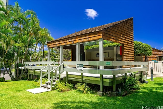 rear view of property featuring a lawn