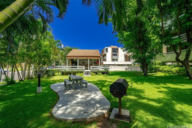 view of home's community with a patio area, a gazebo, and a lawn