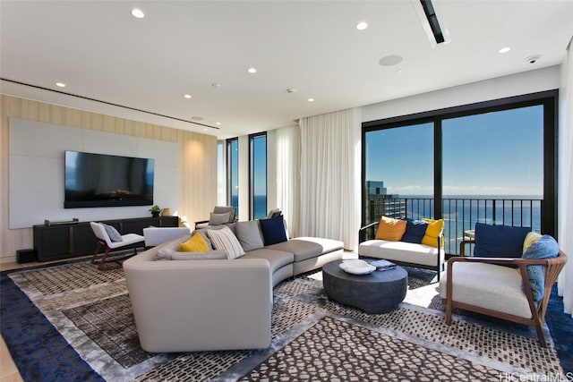 living room featuring a water view and a healthy amount of sunlight