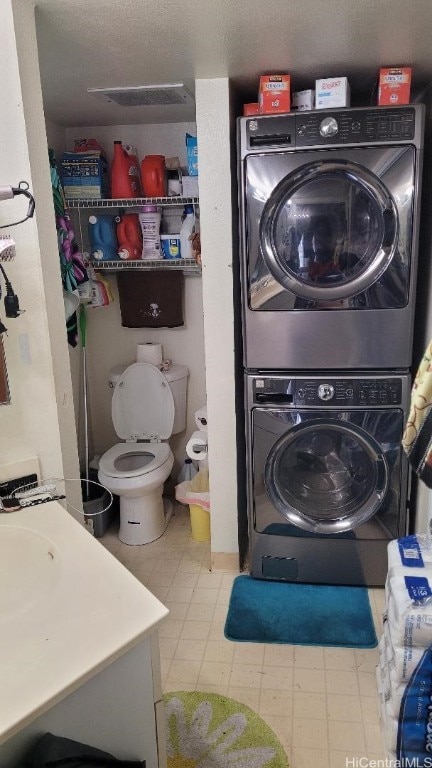 laundry area featuring stacked washer / dryer