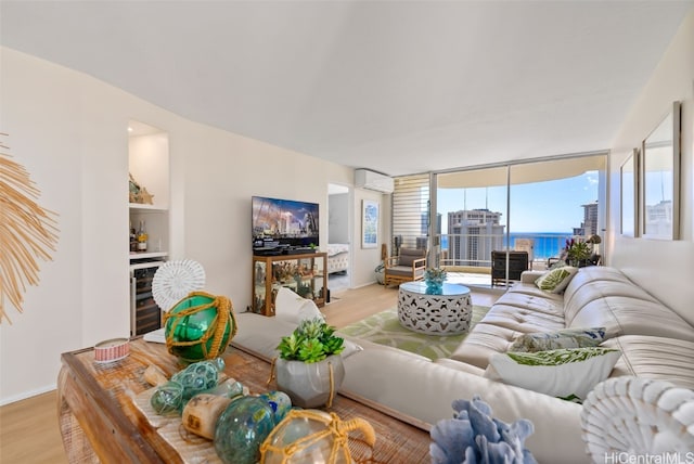 living room with a wall unit AC, beverage cooler, and light wood-type flooring