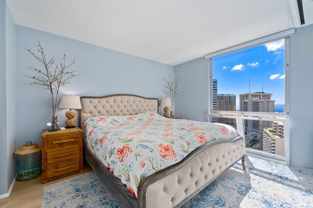 bedroom with wood-type flooring