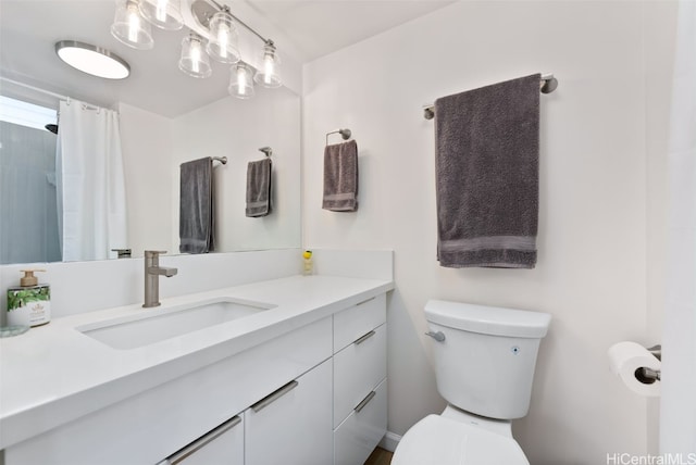 bathroom featuring toilet and vanity