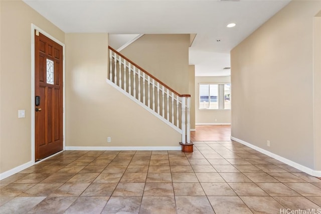 foyer entrance with light tile patterned floors