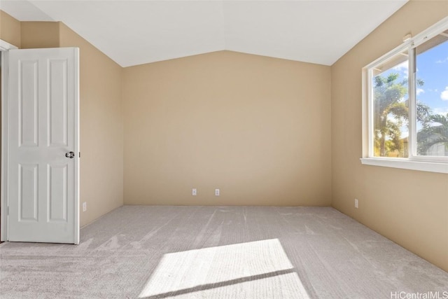 interior space with lofted ceiling and light colored carpet