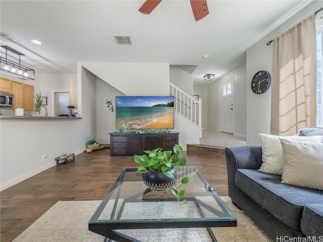 living room featuring dark hardwood / wood-style floors and ceiling fan