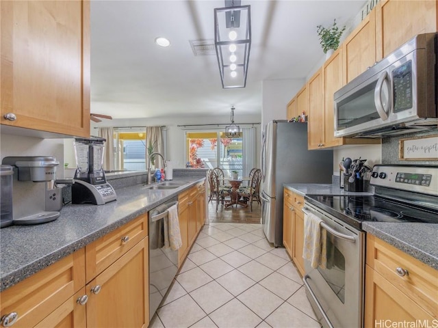 kitchen featuring light tile patterned flooring, sink, hanging light fixtures, light brown cabinets, and appliances with stainless steel finishes