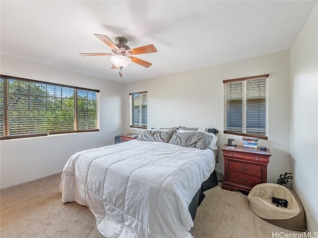 bedroom with light colored carpet and ceiling fan