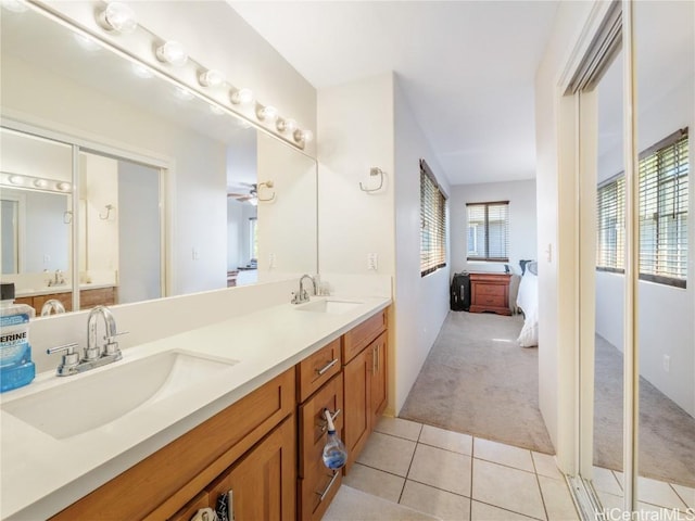 bathroom featuring tile patterned flooring, vanity, and ceiling fan