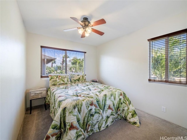 bedroom with ceiling fan and dark colored carpet