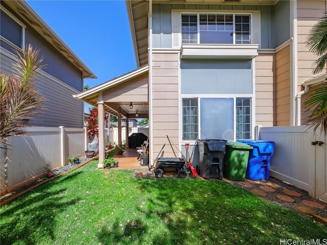 rear view of property with a yard and a patio area