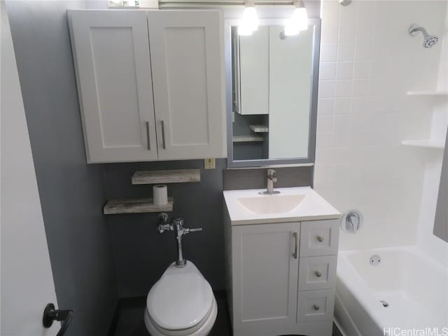 bathroom featuring vanity, a bath, and toilet