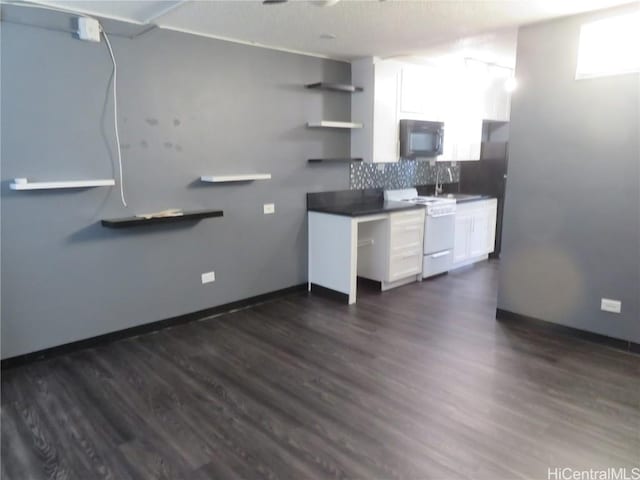 kitchen with decorative backsplash, stove, dark hardwood / wood-style floors, and white cabinetry