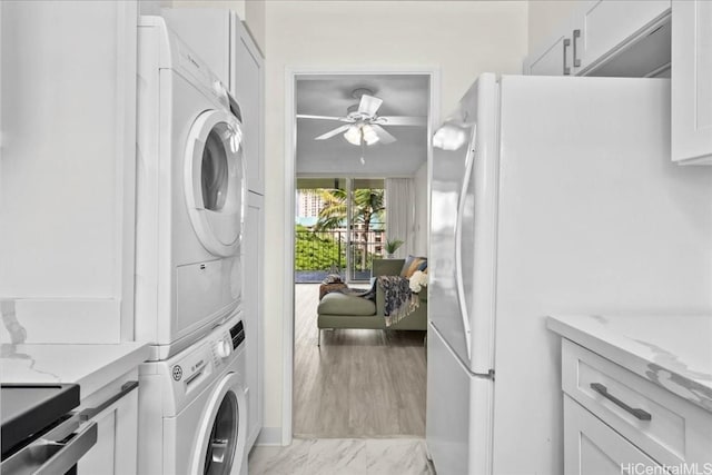 washroom featuring ceiling fan and stacked washer and dryer