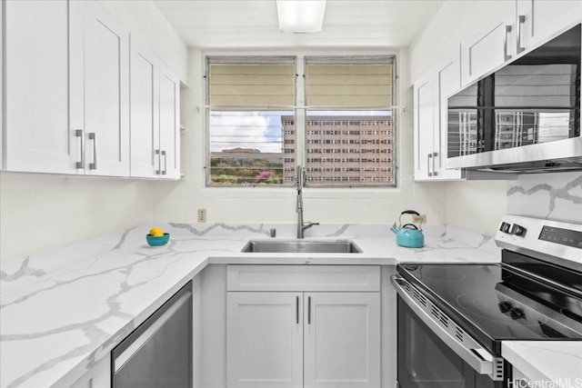 kitchen featuring sink, stainless steel appliances, and white cabinets