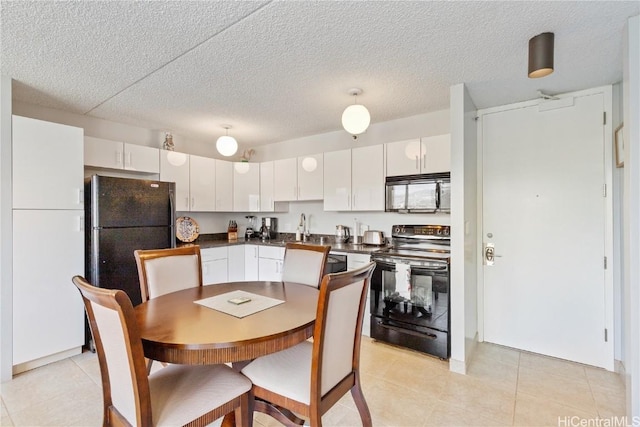 kitchen with black appliances, sink, light tile patterned floors, a textured ceiling, and white cabinets