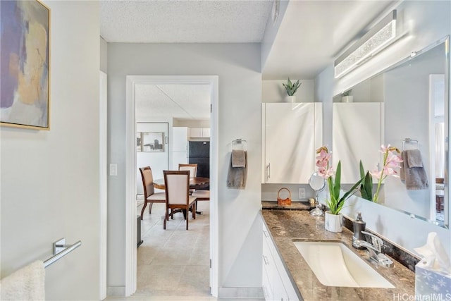 bathroom with a textured ceiling and vanity