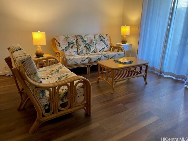 living room featuring a wealth of natural light and dark hardwood / wood-style flooring