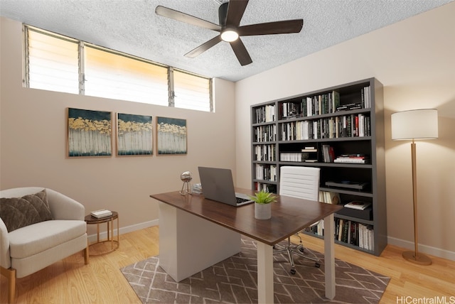 office area with a textured ceiling, hardwood / wood-style flooring, and ceiling fan