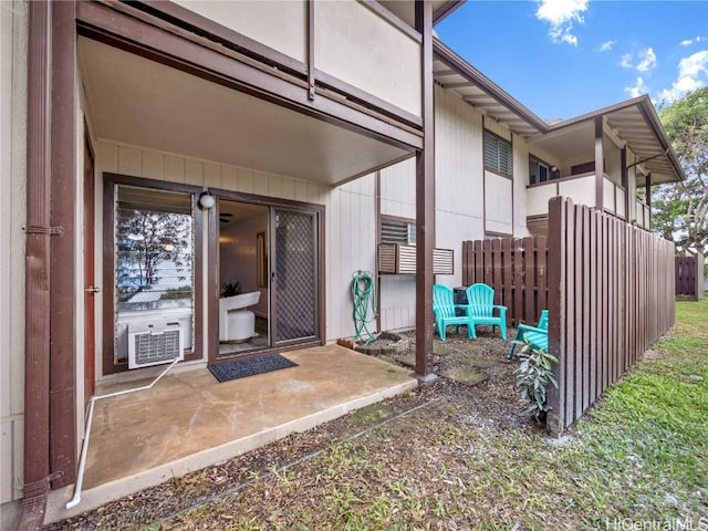 entrance to property featuring cooling unit and a patio area