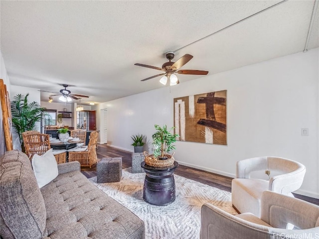 living room with ceiling fan and wood-type flooring