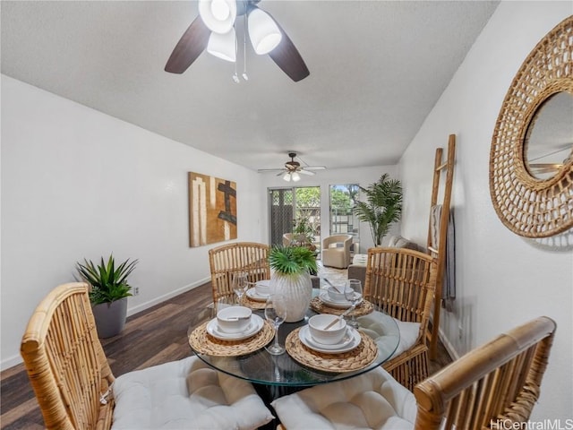 dining space with ceiling fan and dark hardwood / wood-style flooring