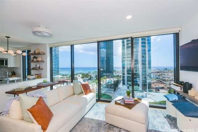 living room with a wealth of natural light, sink, and expansive windows