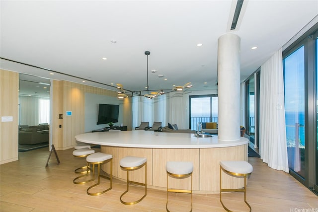 987 Queen St Unit 1401, Honolulu, HI 96814 - kitchen with a sink, open floor plan, light wood-type flooring, and light countertops