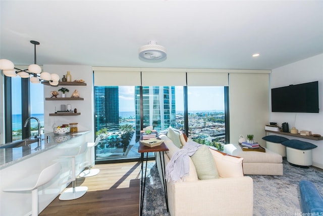 987 Queen St Unit 1401, Honolulu, HI 96814 - living room featuring wood finished floors, floor to ceiling windows, and a chandelier