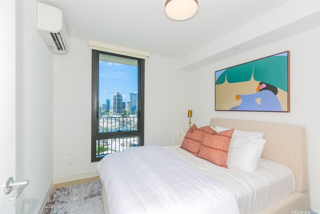 987 Queen St Unit 1401, Honolulu, HI 96814 - bedroom with a wall mounted air conditioner, access to outside, baseboards, and a skyline view