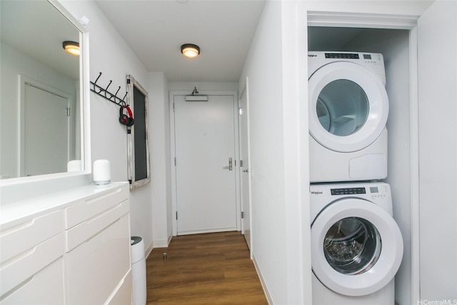 987 Queen St Unit 1401, Honolulu, HI 96814 - laundry area with estacked washer and dryer, dark wood-style flooring, and baseboards