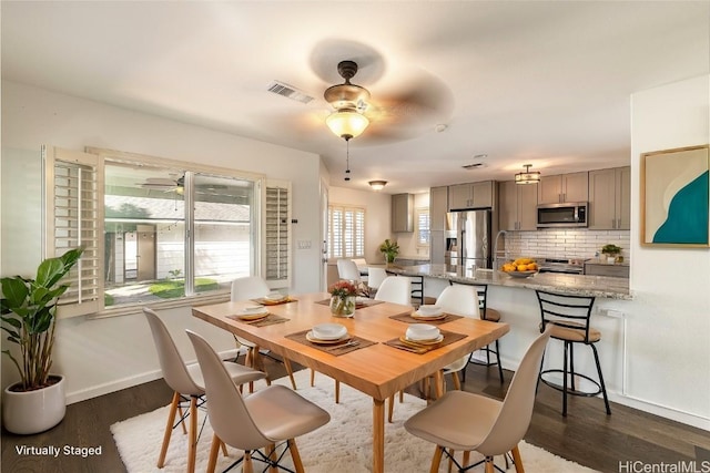 dining area featuring dark hardwood / wood-style floors and ceiling fan