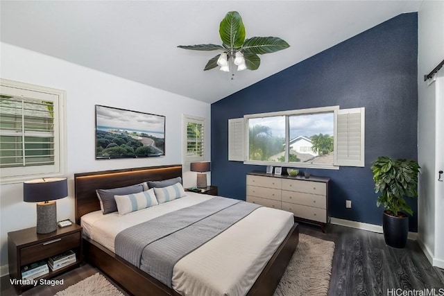 bedroom featuring dark hardwood / wood-style flooring, vaulted ceiling, and ceiling fan