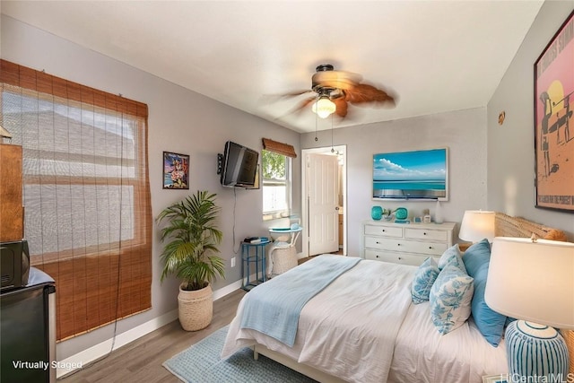 bedroom with ceiling fan and hardwood / wood-style flooring