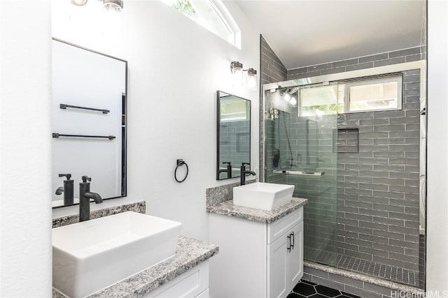 bathroom featuring vanity, a healthy amount of sunlight, and an enclosed shower