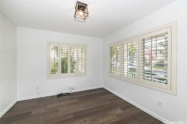 empty room with dark wood-type flooring