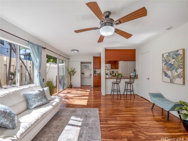 living room with ceiling fan and wood-type flooring