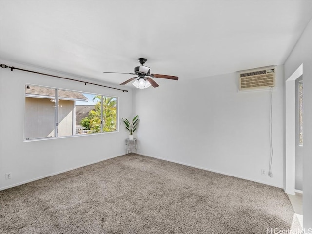 carpeted spare room with ceiling fan and a wall unit AC