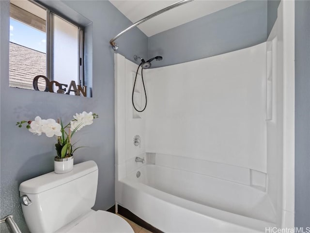 full bathroom featuring washtub / shower combination and toilet