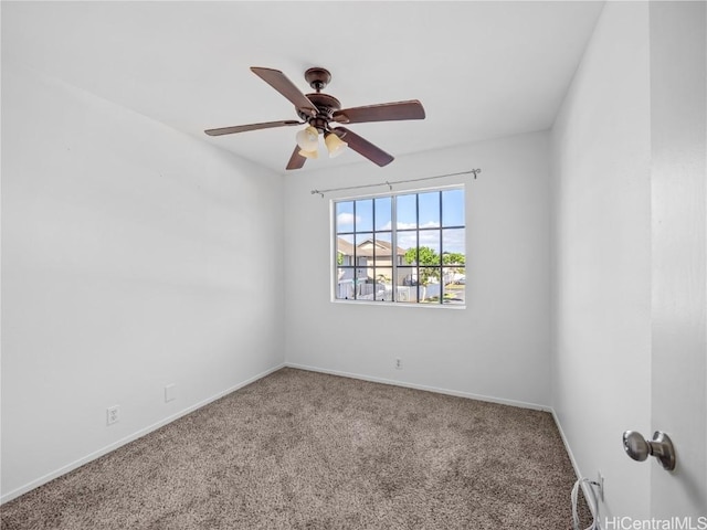 carpeted spare room featuring ceiling fan