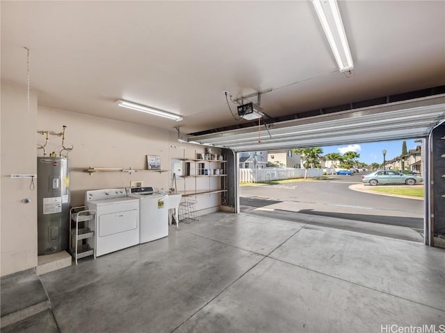 garage with a garage door opener, water heater, and washing machine and clothes dryer