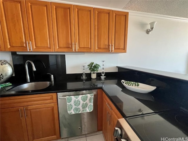 kitchen featuring stainless steel appliances, a textured ceiling, light tile patterned floors, and sink