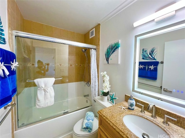 full bathroom with toilet, enclosed tub / shower combo, ornamental molding, and vanity