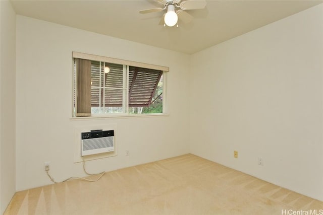 spare room with carpet flooring, a wall mounted AC, and ceiling fan