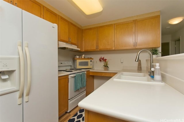 kitchen featuring white appliances and sink