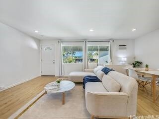 living area with recessed lighting and light wood-style flooring