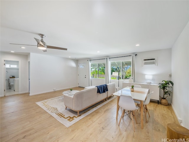 living area with light wood-type flooring, a wall mounted air conditioner, and recessed lighting