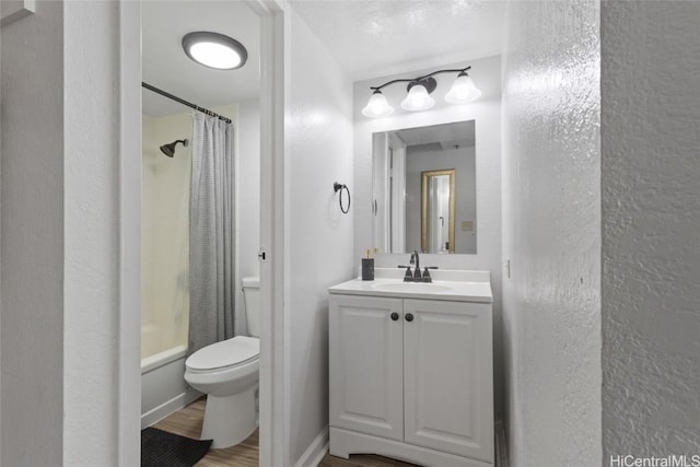 full bathroom with hardwood / wood-style flooring, vanity, toilet, and shower / tub combo