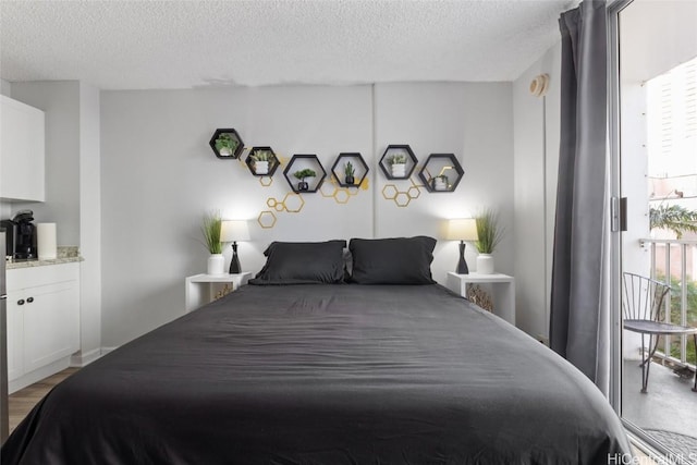 bedroom featuring light hardwood / wood-style floors and a textured ceiling