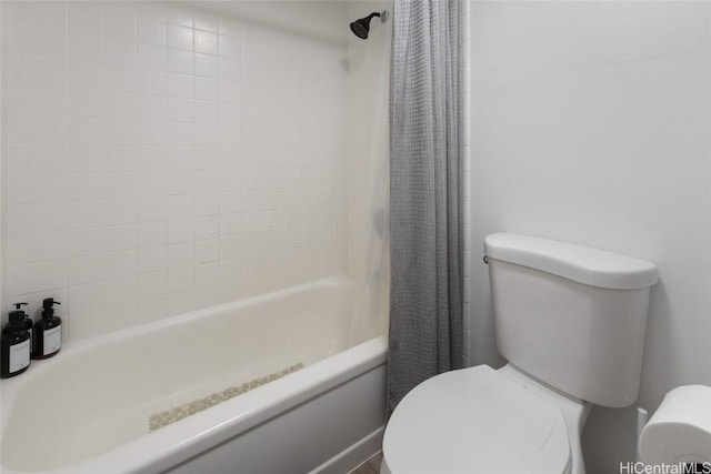 bathroom with shower / bathtub combination with curtain and toilet